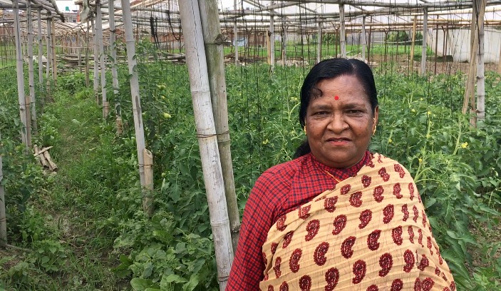 woman stands in front of her crop