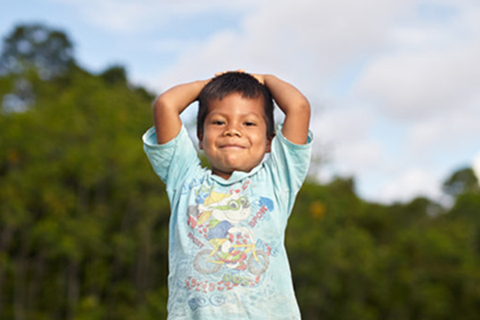 Young boy smiling outdoors