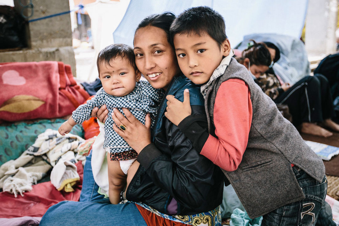 A smiling family hugs each other in a recovery center