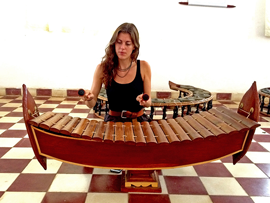 woman playing a gambang
