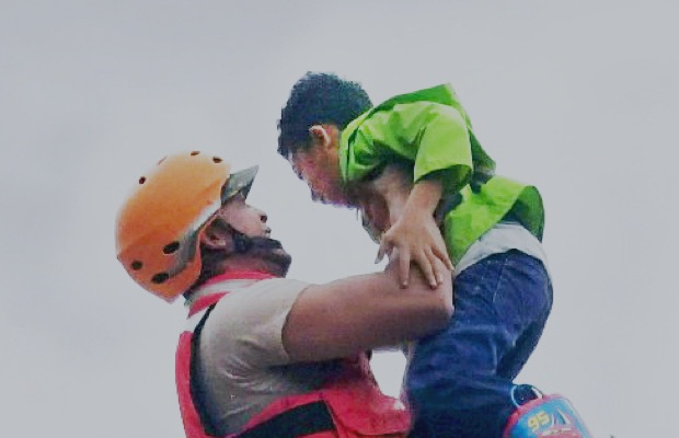 Disaster rescue worker assisting a child