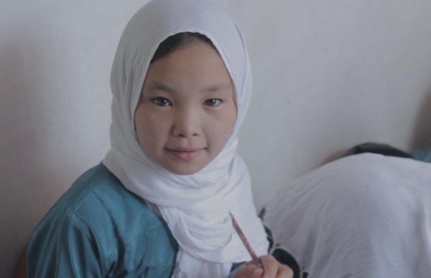 Child holding a writing implement