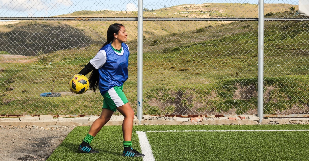 Girl playing soccer. giving goals