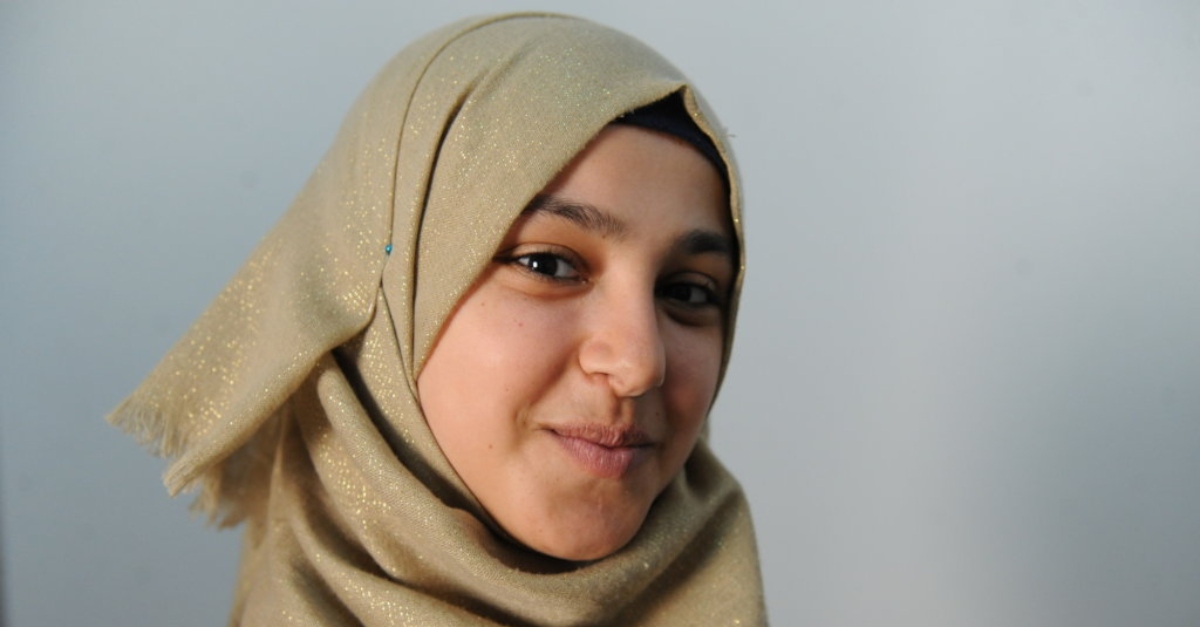 young girl refugee smiling at camera. displaced persons