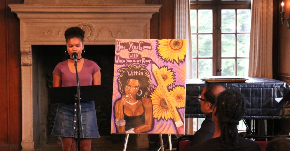 Woman speaking in front of a crowd. Racial justice nonprofit