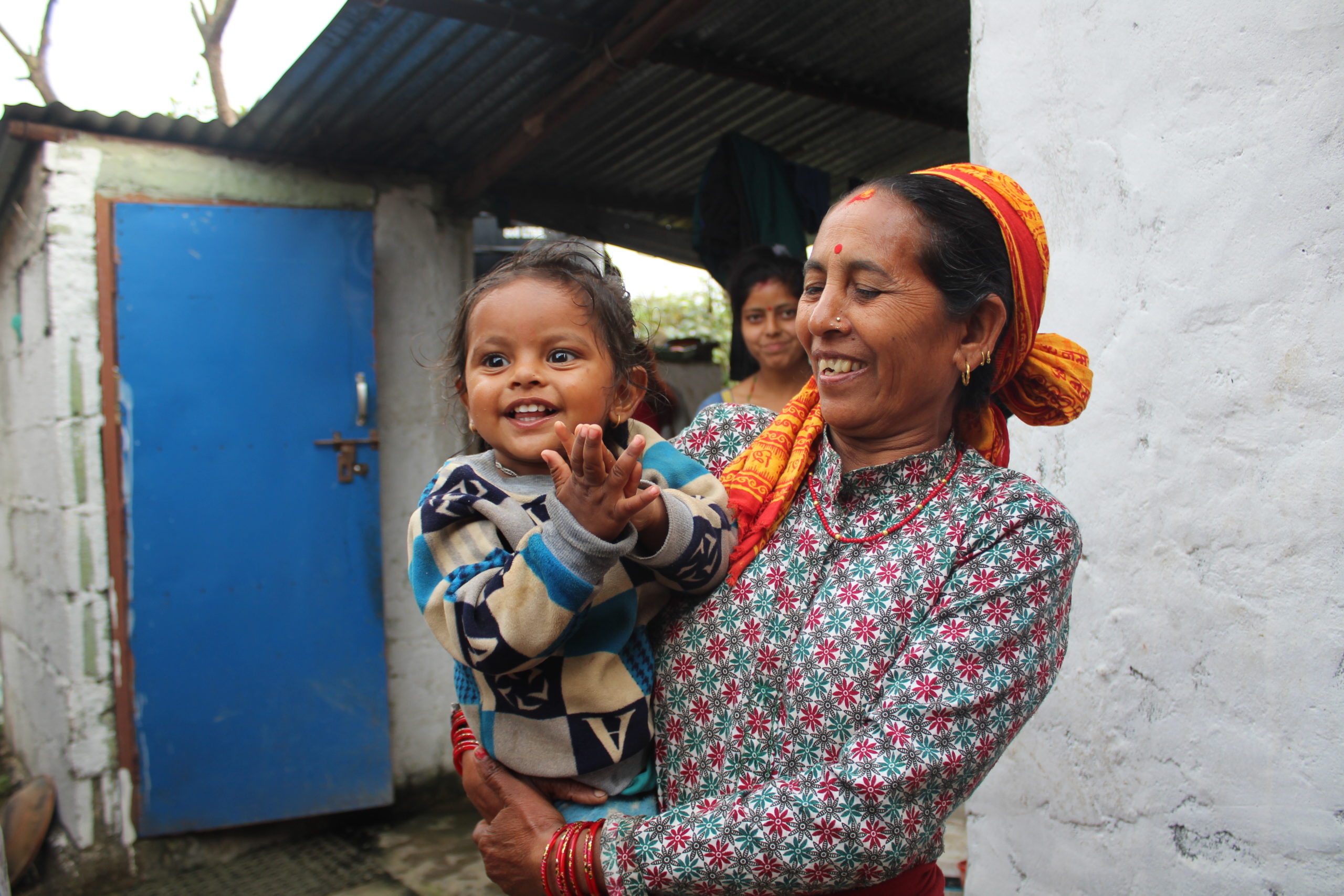 a woman smiling and holding a baby. amazing nonprofit photos