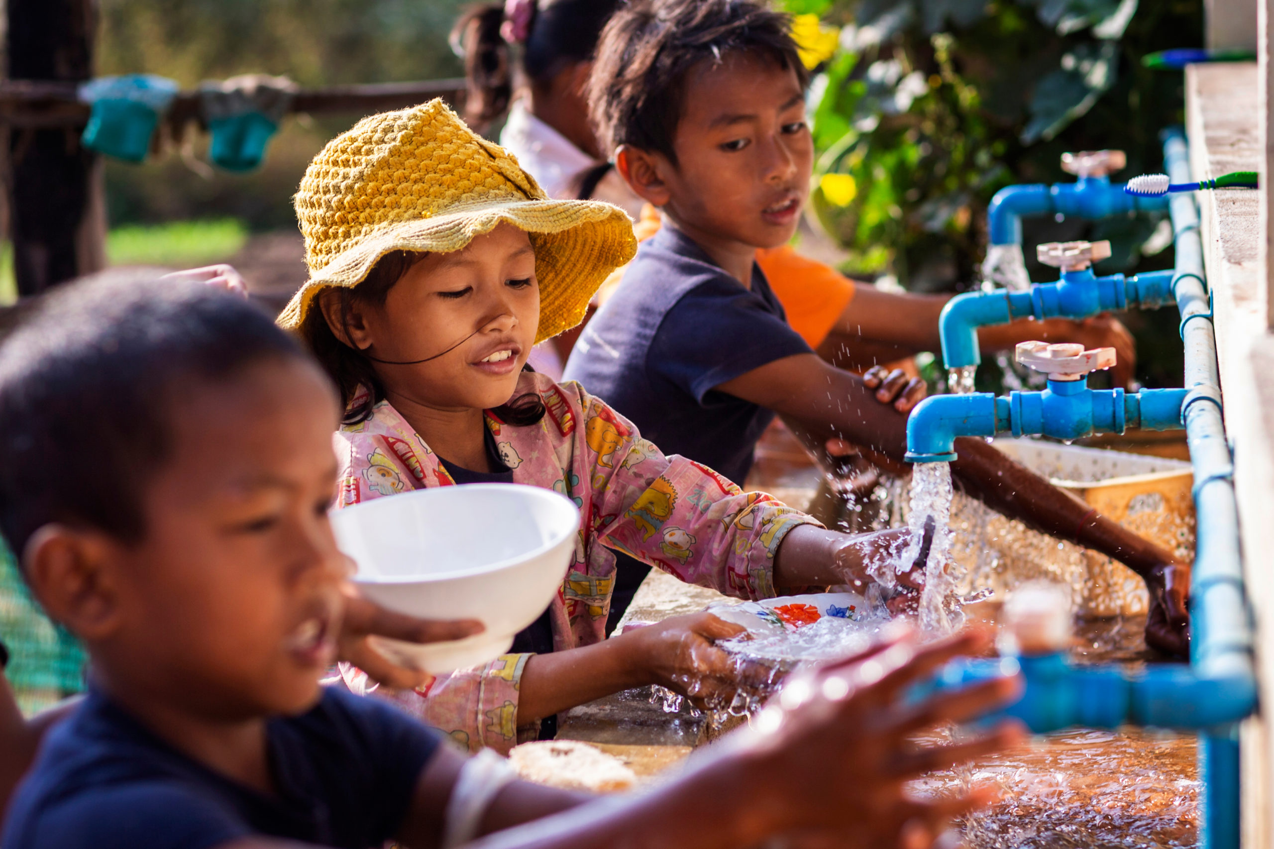 Several children washing bowls together