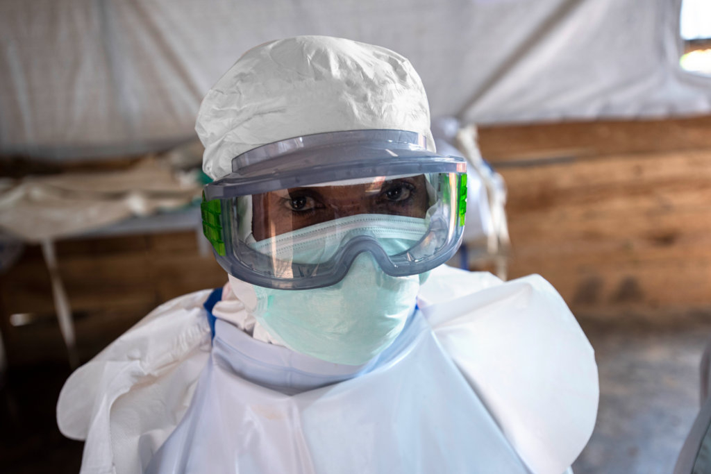 A nurse in PPE including googles, a fave mask, and a cap