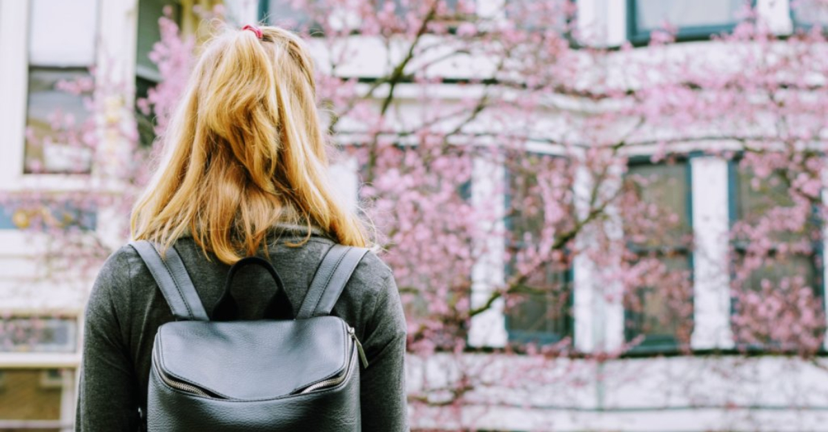 A woman looking at apartment buildings in America