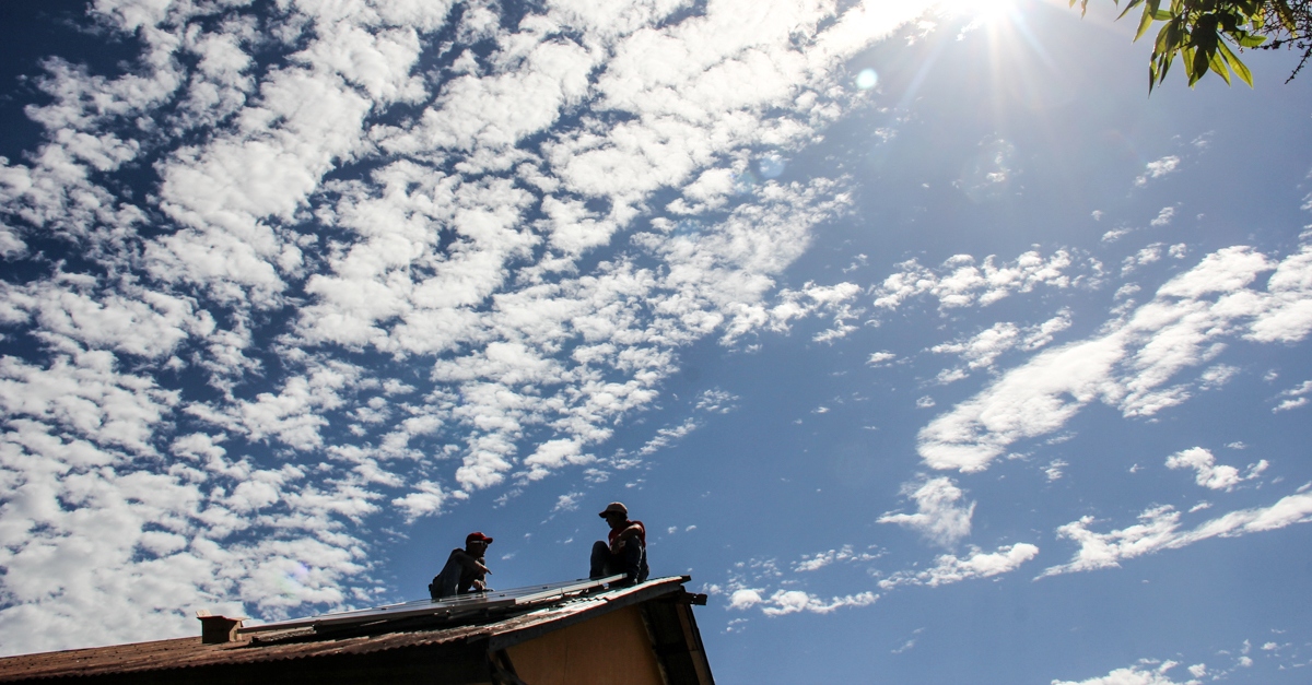 A photo of the sky with two people on the roof enjoying the clean air to introduce facts about air pollution