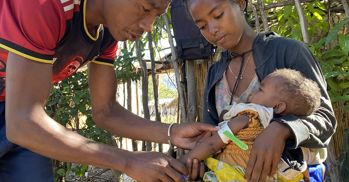 A health worker assesses the body fat of a child in Madagascar. Photo by Charlie Reid for SEED Madagascar.