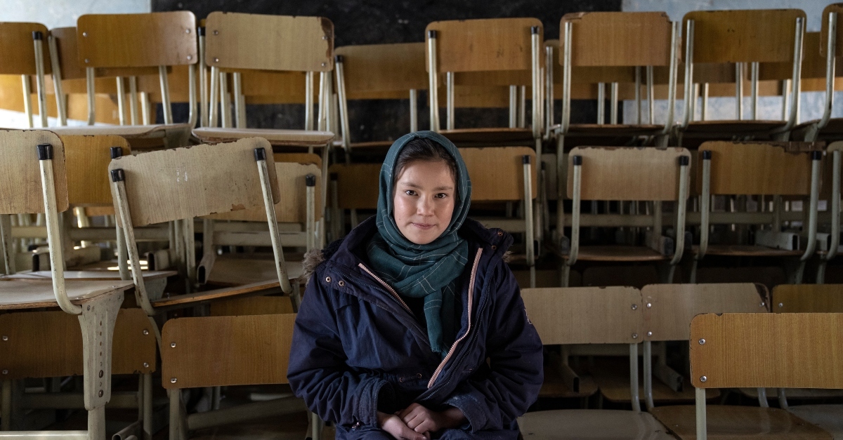 schoolgirl poses for a photo in an empty classroom taliban women ngo
