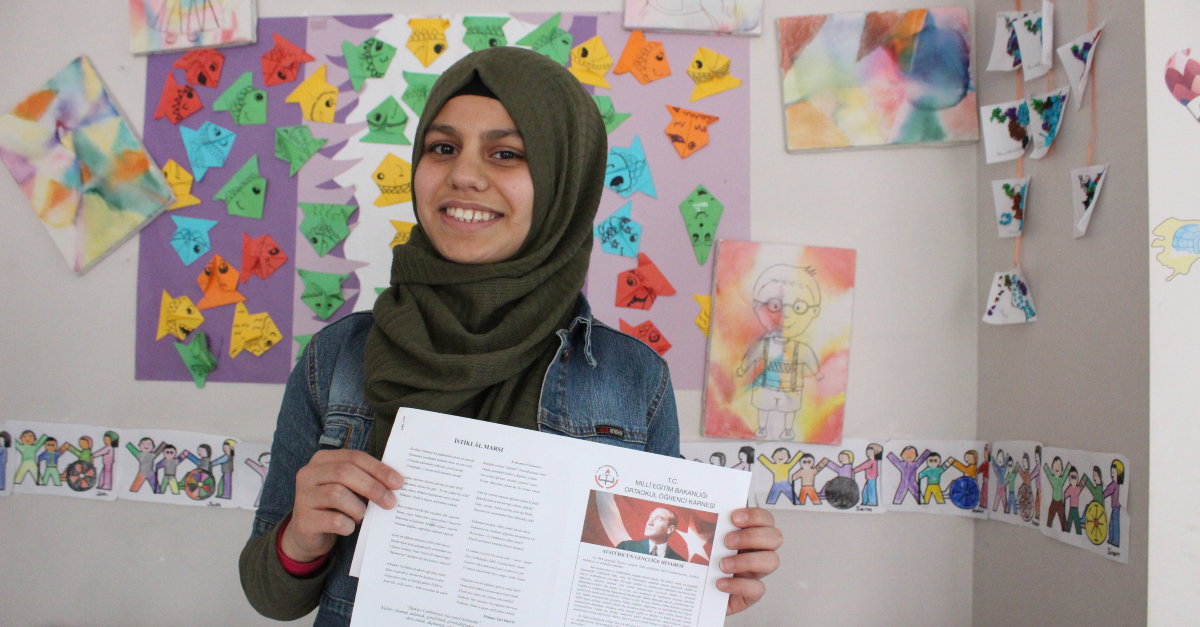 young woman holds certificate and smiles at the camera. tech in disaster relief