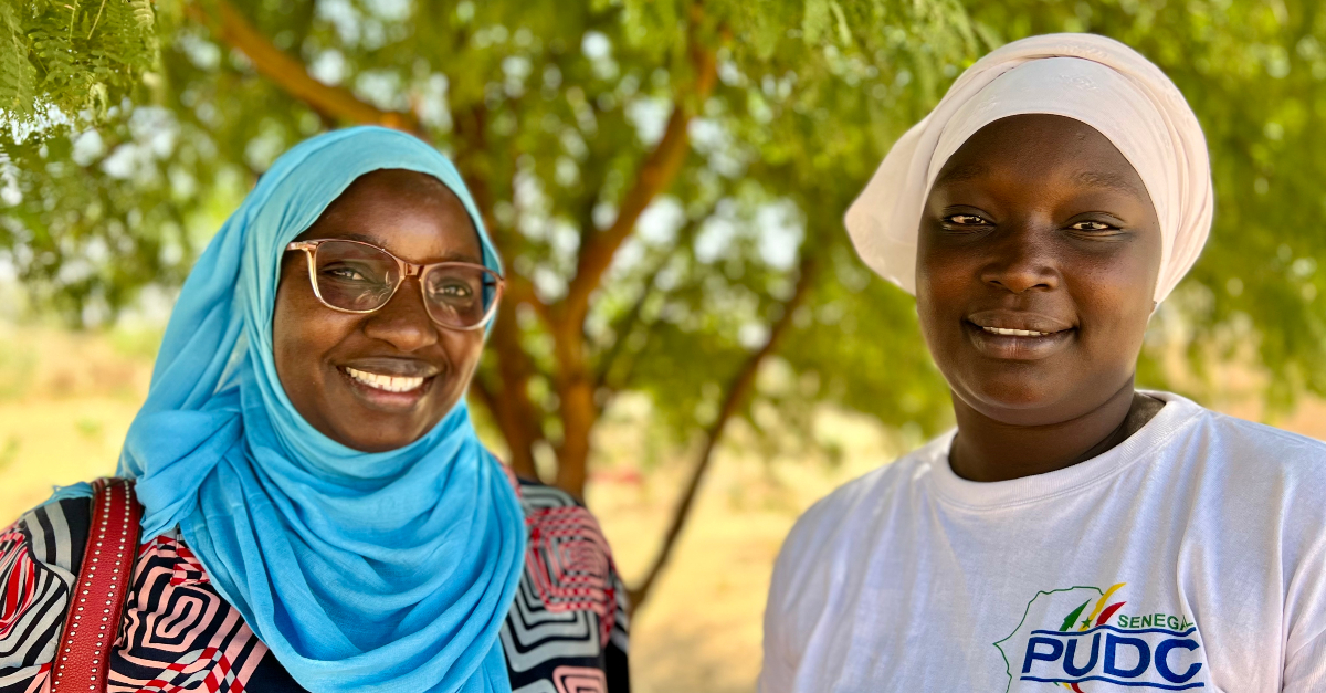 Two women smile at the camera together