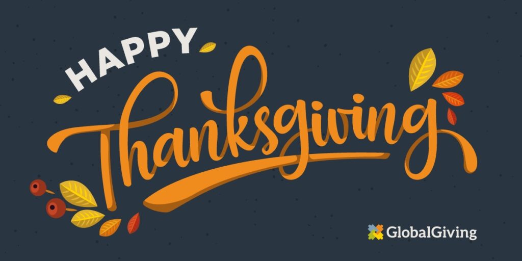 Happy Thanksgiving is written on a blue background in this Thanksgiving gift card design. Graphics of leaves and berries decorate the edge of the words, and a GlobalGiving logo is in the bottom right corner.