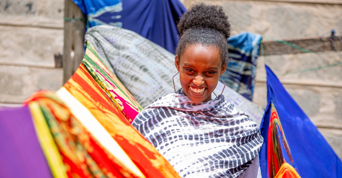 woman stands next to clothes line, smiling at the camera young feminist movements