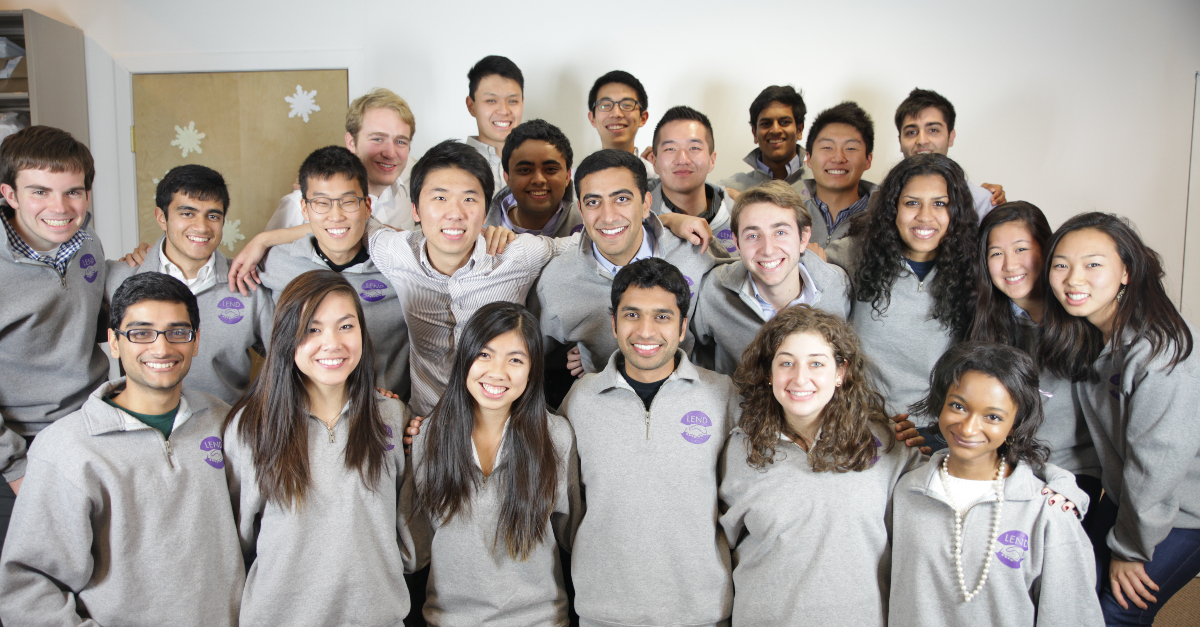 Team of employees smile at the camera in a group shot