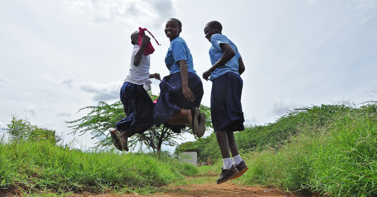 three girls in mid-jump