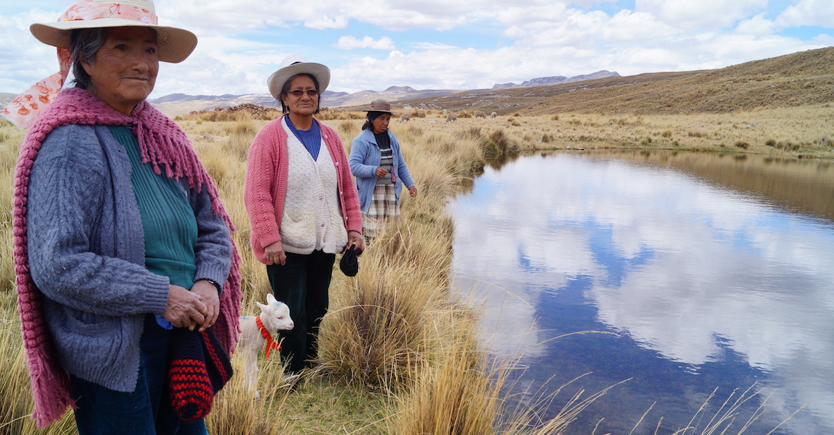 Three women stand next to a pool of water in the andes mountains ancestral water technologies