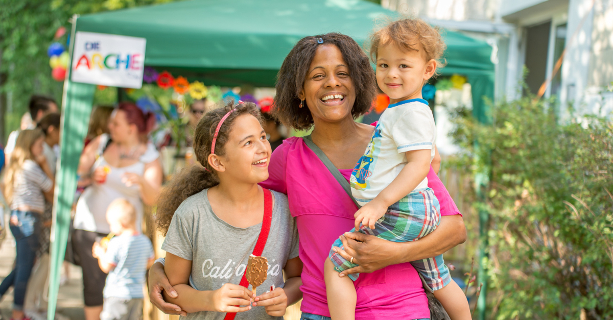 woman and two children at festival laugh together