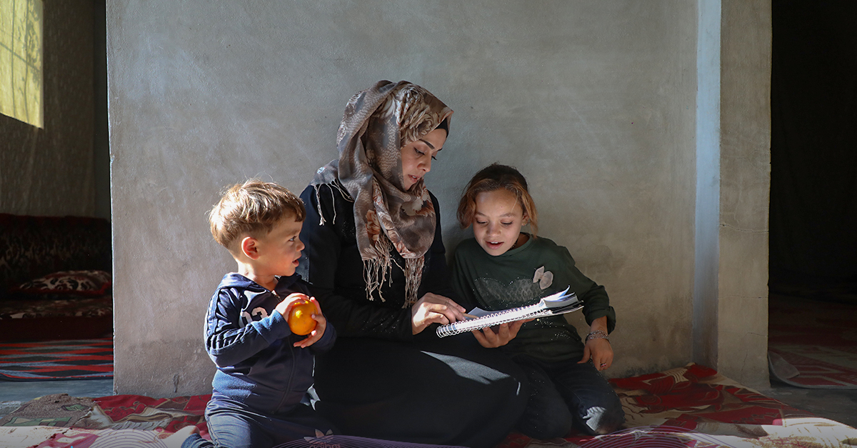 woman reads with two children top articles of 2023