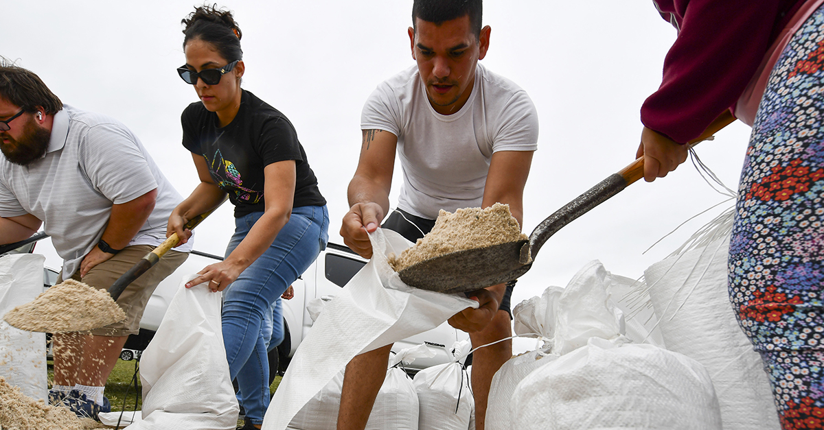 Residents of Orange County, Florida, collect sandbags for free to protect themselves from Hurricane Milton, which is expected this week. The images are captured at Osceola Heritage Park in Orange County, Florida, on October 8, 2023. (Photo by Ronaldo Silva/NurPhoto via AP)