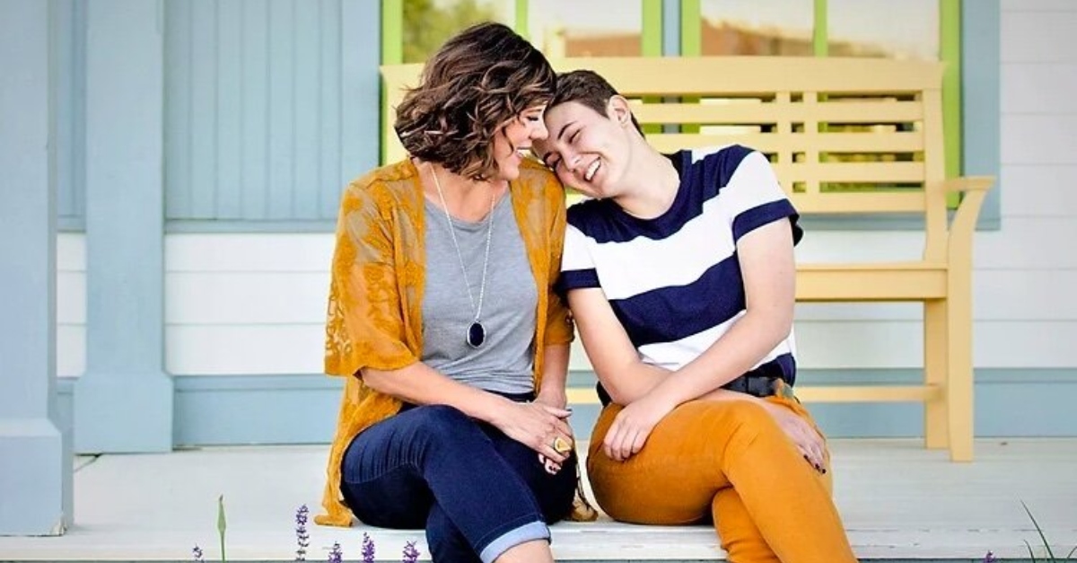 A teen in the LGBTQ+ family sits with their mom