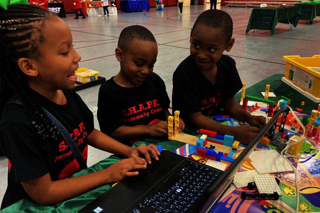 A group of three children playing together.