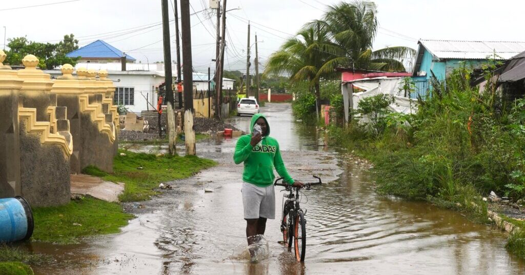 Man stands in flooded street