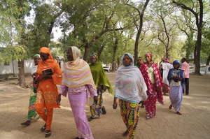 Women leave sewing class and return home.