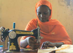Mairamou, APAD Leader, teaches sewing.