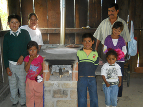 Family with their new fuel-efficient stove