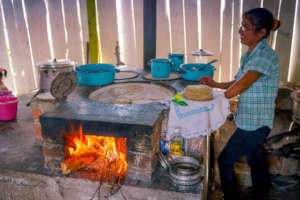 Graciela makes tortillas in fuel-efficient stove