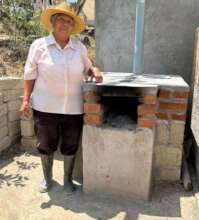 Ofelia (Dona Ofe) with a fuel-efficient stove