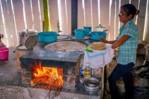 Woman in El Rosario cook on fuel-efficient stove