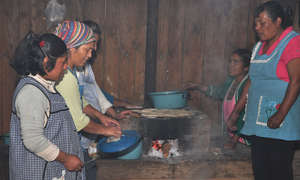 Women cooking with fuel-efficient stoves