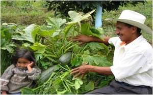 Don Federico shows his daughter an organic squash