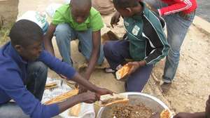 Talibe Kalidou Balde helps prepare the meal