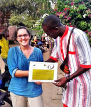 Abdou giving Simone a certificate of appreciation