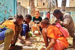 Playing checkers with enthusiastic talibe children