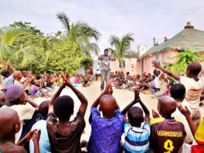Teacher Abdou leading singsong in MDG center