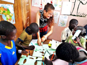 Joy drawing with younger talibe children