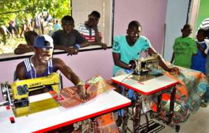 The tailoring center is a magnet for young talibes
