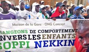 Arouna (on left) and fellow marchers in the street