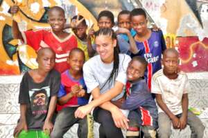 Mayliss Odadan surrounded by children