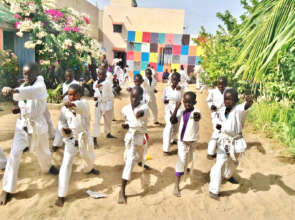 Yaya (in purple) practicing katas with his class