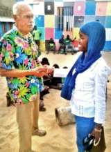 Chuck greets Maison de la Gare nurse Awa Diallo