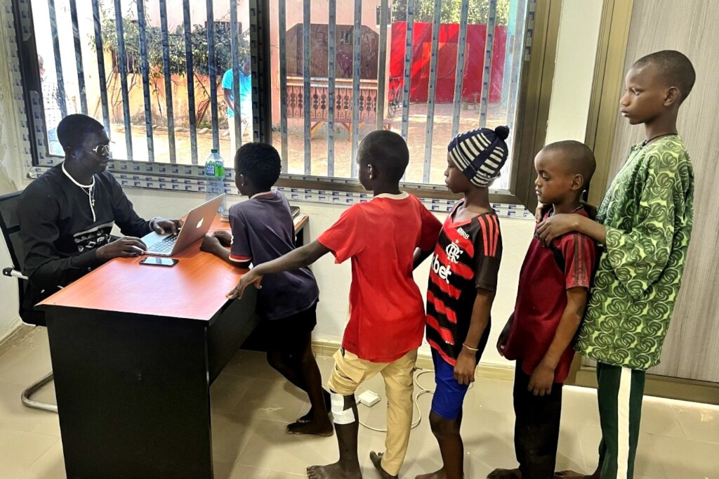 Noel warmly welcomes and registers children