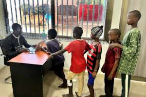 Noel warmly welcomes and registers children