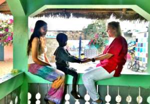 Lise and volunteer Graciela with a talibe child